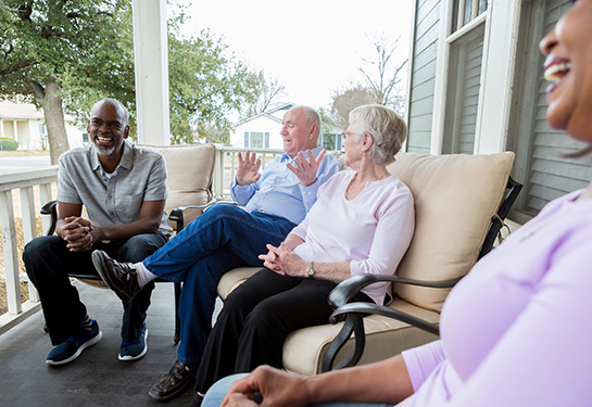 Four seniors sitting on the porch 