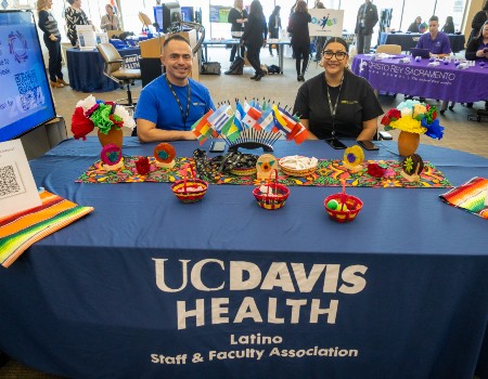 LSA ERG members smiling while tabling an event at UC Davis Health 