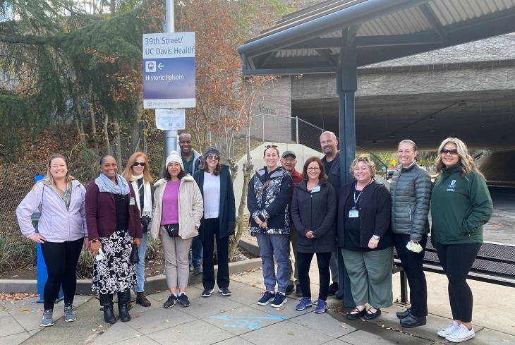 Group of employees on a light rail field trip.