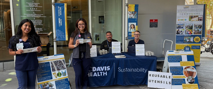 Staff sitting at a Sustainability information booth
