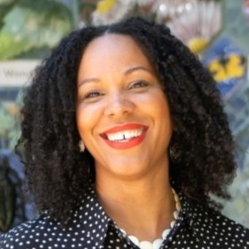 Headshot of Theanne Griffith against a colorful background. 