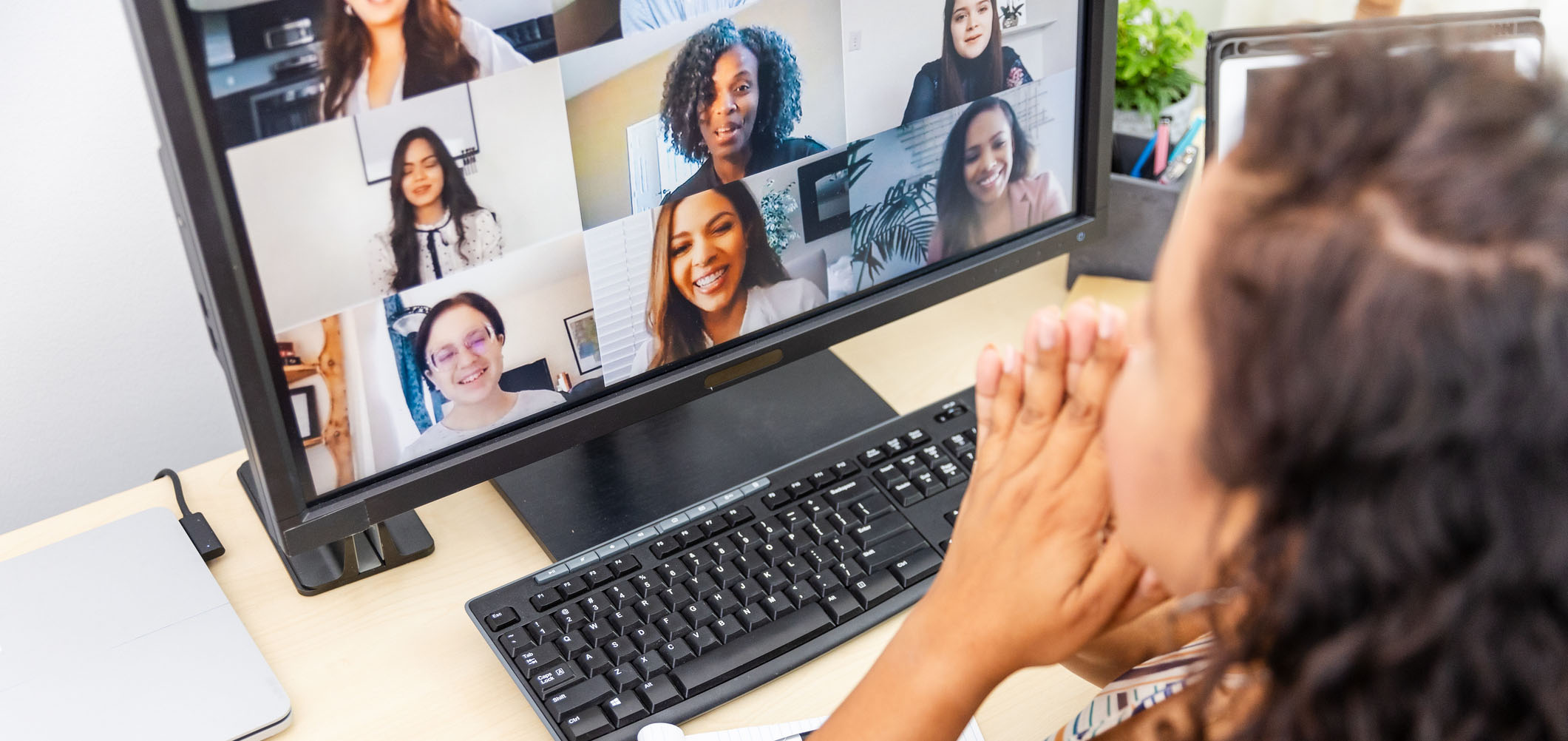 Woman participates in a video conference call with colleagues. 