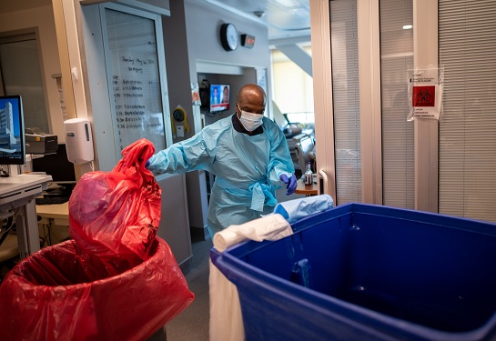An EVS staff cleans a patient room