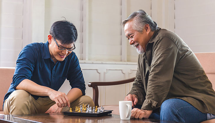 father and son playing chess