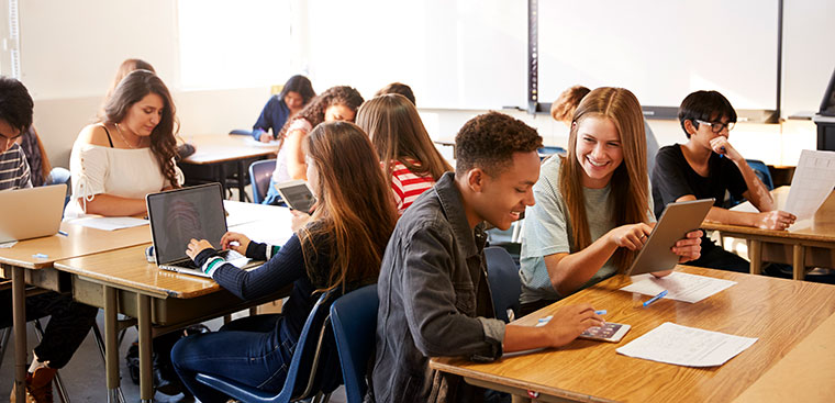 high school students sitting at desks working together