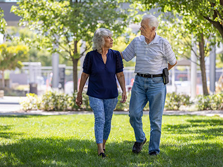 older female lung cancer patient walking with her husband