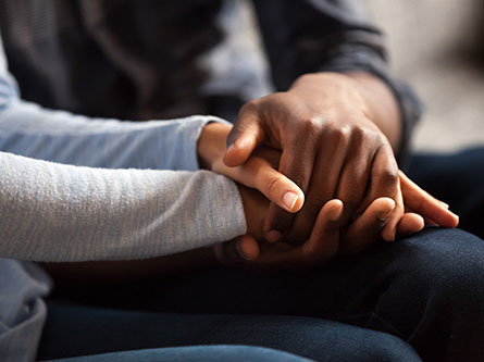 two sets of hands holding each other, miscarriage signs