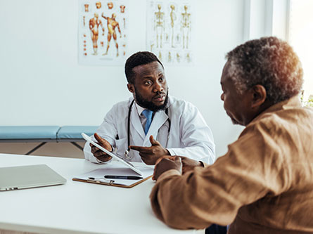 older man talking to a provider about his pancreatic cancer symptoms and treatment options