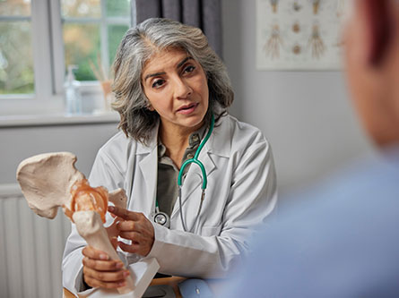 Surgeon talking to a patient about hip replacement
