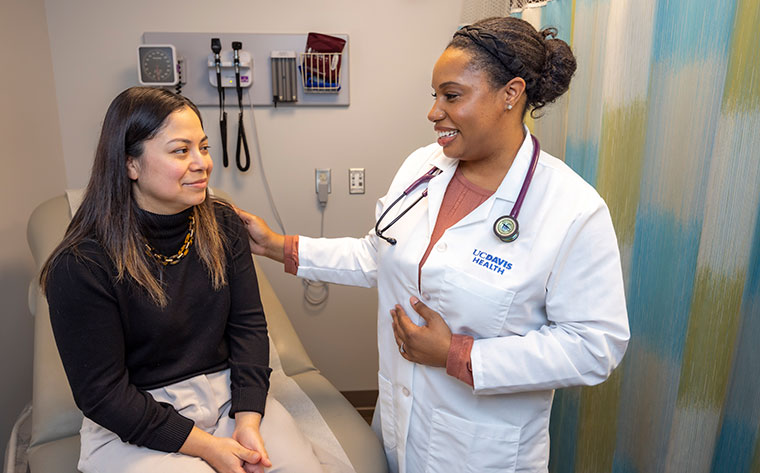 Patient sitting talking with primary care provider about health screenings