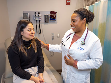 Patient sitting talking with primary care provider about health screenings