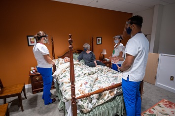 Nursing students in a simulation exercise in the Moore Hall home health suite.