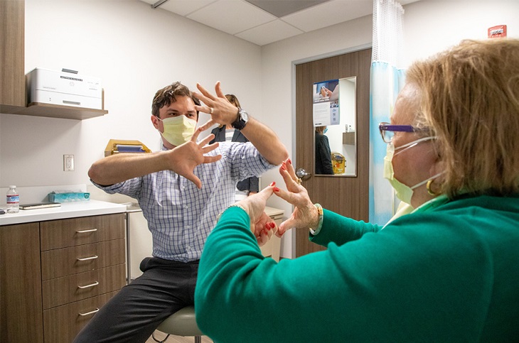 healthcare provider mirroring hands of patient