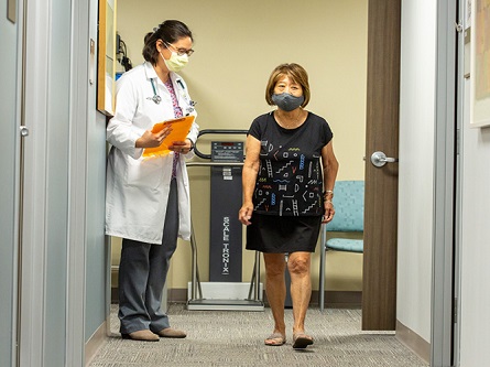 healthcare provider walking alongside adult female