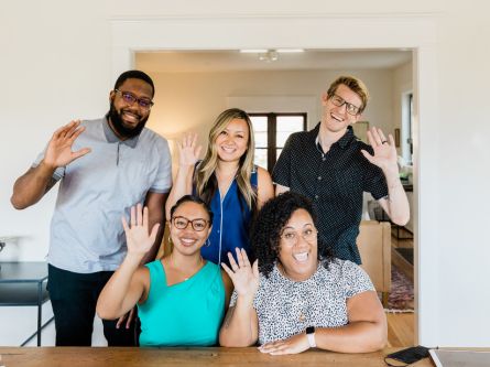 group of people waving hello