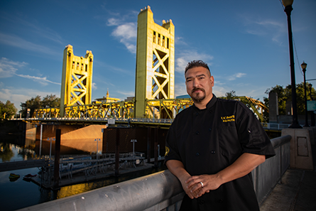 Executive Chef Santana Diaz standing in front of the Tower Bridge