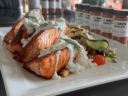 Mediterranean spiced salmon with yogurt and vegetables on a plate