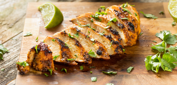 Grilled chicken with spices on a cutting board