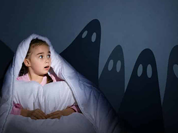 young girl having nightmares in bed