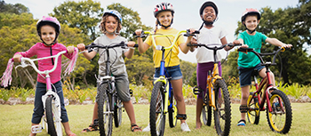 several kids pose on their bikes