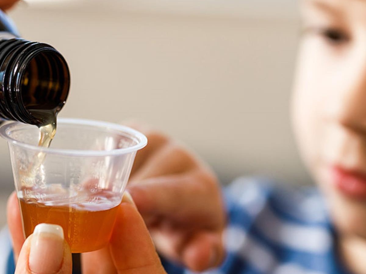 kid drinking liquid medicine