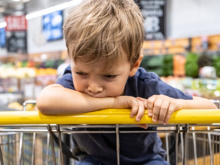 boy sitting in grocery cart