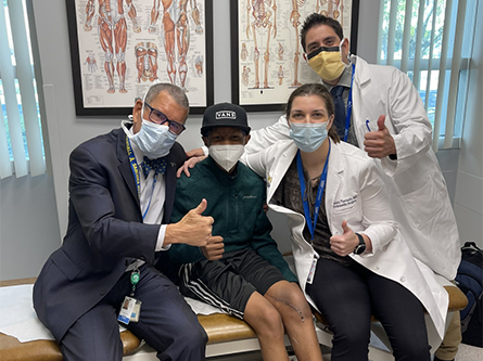 Darren and his UC Davis Children’s Hospital team – R. Lor Randall, Raminta Theriault and Judas Kelley (left to right) – celebrate after surgery.