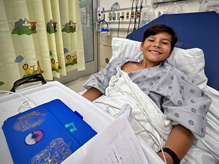 Smiling boy in a hospital bed