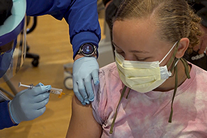 Teen getting a COVID-19 vaccination