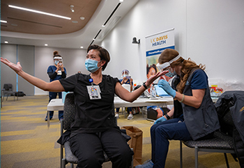 A nurse receives the first Pfizer/BioNTech at UC Davis Health