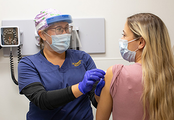 woman getting her covid-19 vaccine