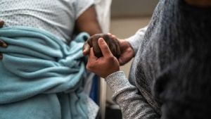 Holding hands with patient