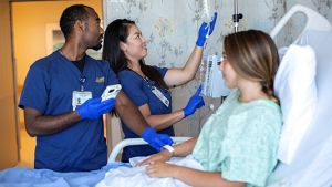 Nurses setting an IV with patient