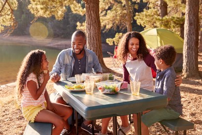 Family sitting at a picnic table together
