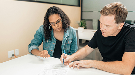 Two People signing document