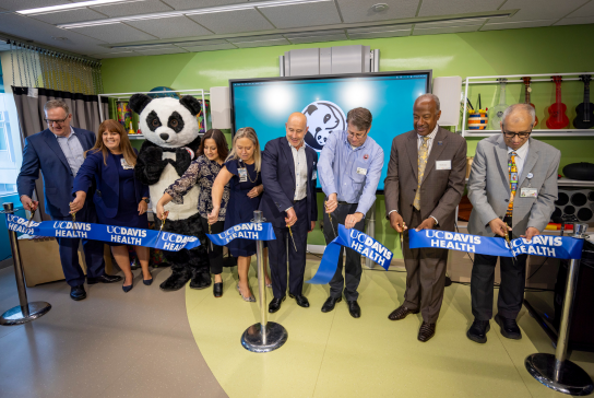 UC Davis Health leadership and Pei Pei cut the ribbon for the Panda Cares Center for Hope.