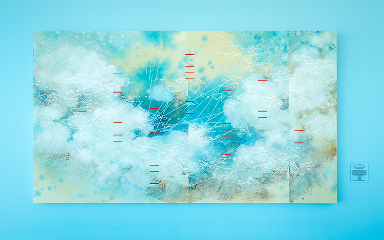 Close up of the Between Two Rivers art piece on a blue wall.