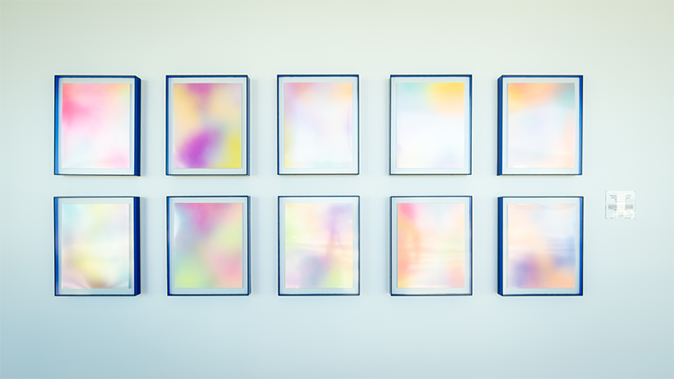 Close up of the ten Chroma Clusters art pieces hanging on a wall.