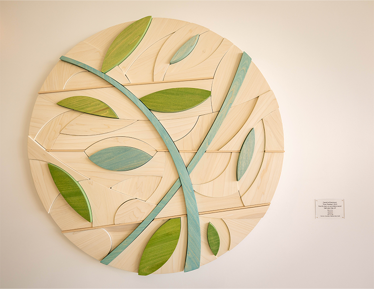 Close up of the Free Floating art piece on a white wall.