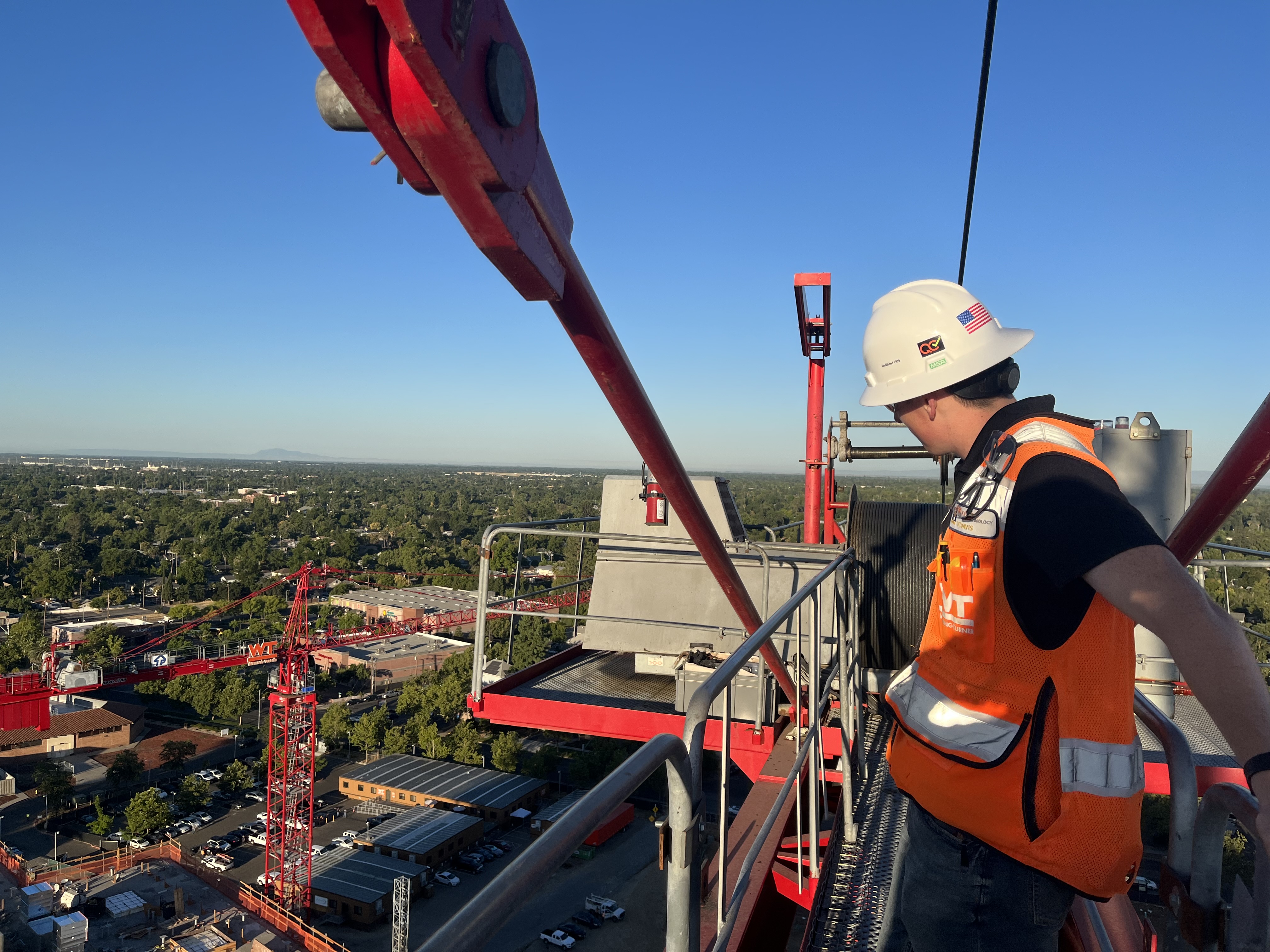 worker surveying a construction project