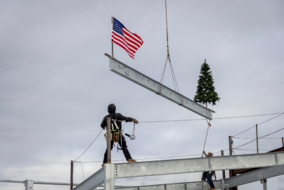 construction rig looks up into the air at the final folsom medical office building beam being placed