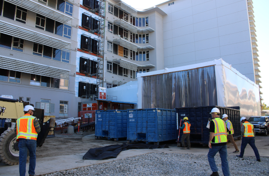 Construction workers in front of the North/South Tower.