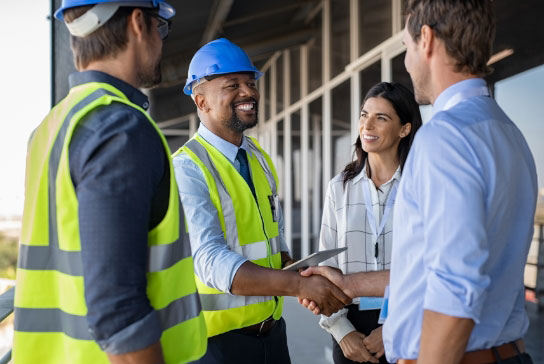 people talking and shaking hands on construction site