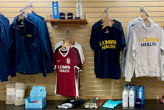 Gift shop shelf and display with UC Davis health t-shirts and sweatshirts.