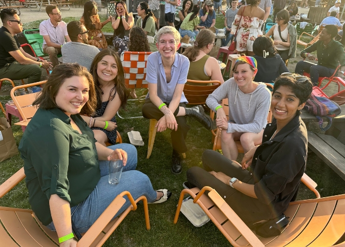 Family medicine residents sitting outdoors in lawn chairs.