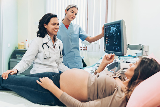 A pregnant women receiving an ultrasound treatment.