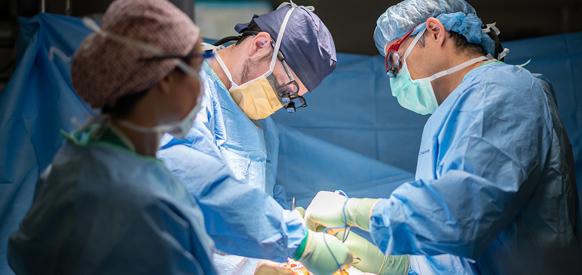 Liver transplant surgeons performing surgery.