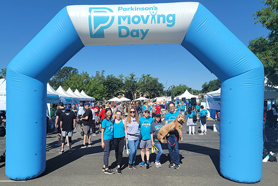 UC Davis fundraising team gathers under starting line arch for Parkinson’s Moving Day
