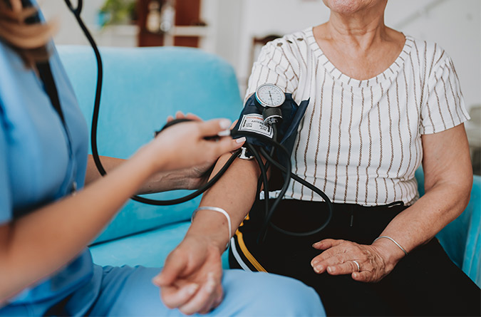 Patient getting blood pressure taken by nurse