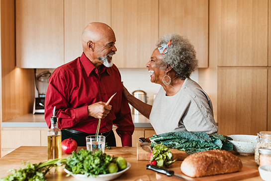 Older adult couple cooking a healthy meal